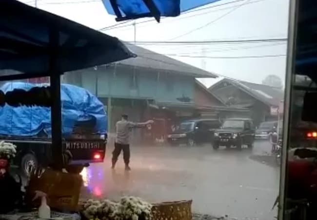 diguyur_hujan_deras_polisi_di_simalungun_ini_bertahan_atur_lalulintas